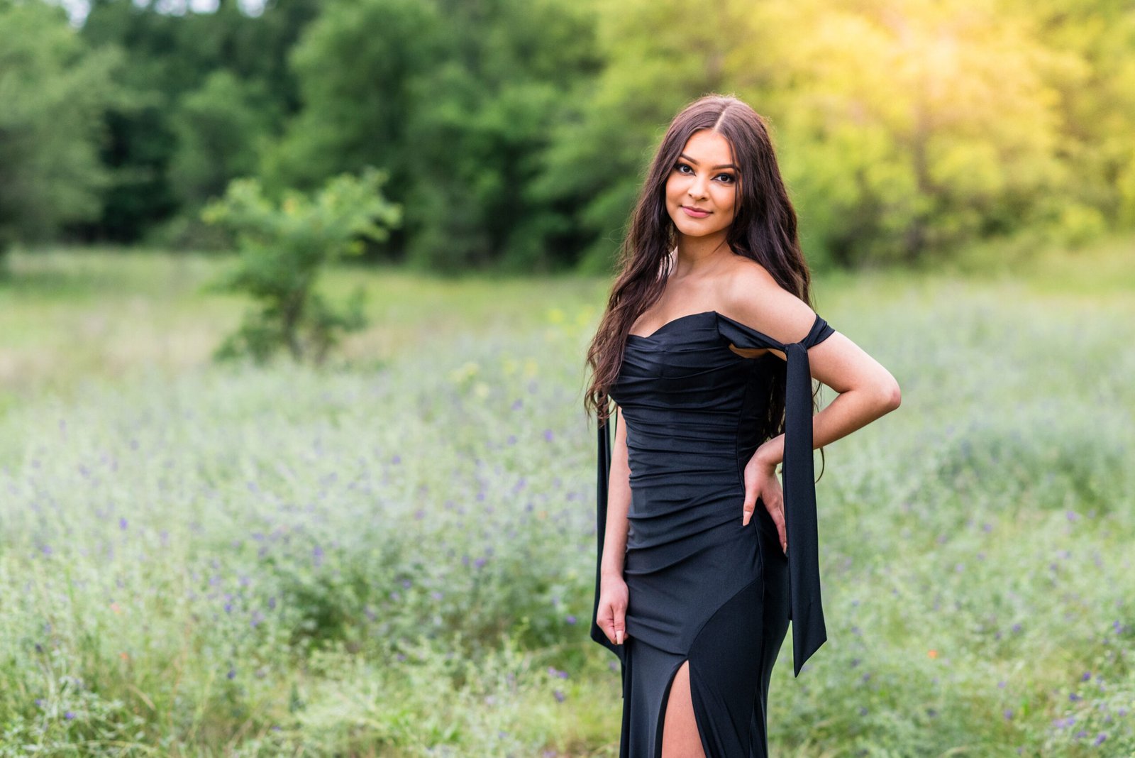 Senior girl in a scenic green field during golden hour at Murrell Park Flower Mound, Texas, in the fall season, highlighting a warm and natural outdoor portrait photography setting